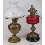 A Victorian brass oil lamp, having a milk glass shade, h.47cm; together with another Victorian brass