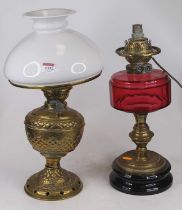 A Victorian brass oil lamp, having a milk glass shade, h.47cm; together with another Victorian brass