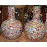 A pair of large Chinese porcelain vases, each of globular form, enamel decorated with flowers, h.