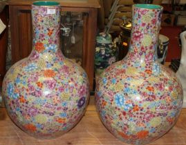 A pair of large Chinese porcelain vases, each of globular form, enamel decorated with flowers, h.