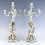 A pair of Schierholz porcelain three branch figural table candelabra, late 19th century, each