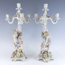 A pair of Schierholz porcelain three branch figural table candelabra, late 19th century, each