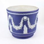 A Wedgwood blue jasperware jardiniere, relief decorated with classical figures and fruiting swags,