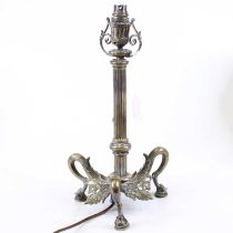 A 19th century brass table lamp in the form of a reeded column, standing upon three paw feet, h.40cm
