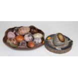 A collection of polished hardstone specimen eggs, to include rose quartz, agate and serpentine, in a