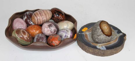 A collection of polished hardstone specimen eggs, to include rose quartz, agate and serpentine, in a