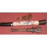 A digeridoo handpainted with a kangaroo, together with a tribal souvenir club and one other tribal