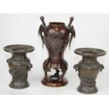 A pair of Japanese bronze vases, each decorated in high relief with a dragon, height 13cm,