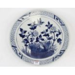 A Chinese export blue and white charger, underglaze decorated with birds amidst flowers and foliage,