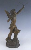 An Austrian pottery model of Cupid, early 20th century, shown leant on a stump with bow raised,