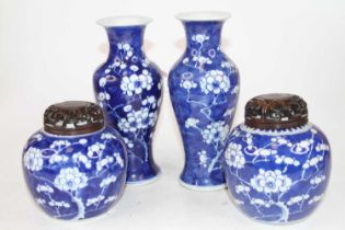 A pair of Chinese porcelain vases, in the Prunus pattern of inverted baluster shape, each on a