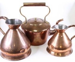 A Victorian copper range kettle, h.35cm; together with two victorian copper measuring jugs, the