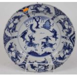 A Chinese blue and white porcelain dish, Kangxi period, decorated with warriors, six character