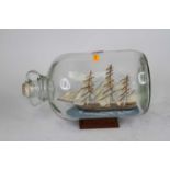 A model of the Cutty Sark contained within a glass jar, height 20cm