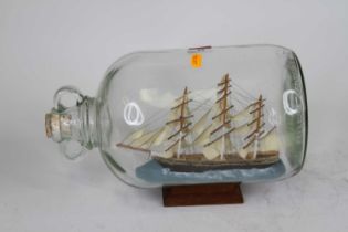 A model of the Cutty Sark contained within a glass jar, height 20cm