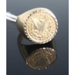 A gilt metal sovereign type ring containing a replica of a US one dollar, size X