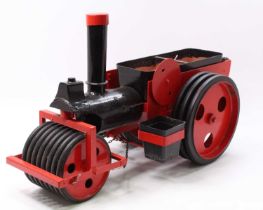 A scratch built garden planter in the form of a live steam roller traction engine handpainted in red