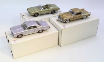 A collection of three Danbury Mi9nt 1/24 scale diecast vehicles to include a 1957 Studebaker, a 1965