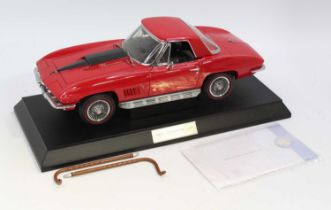 A Franklin Mint Connoisseur Series 1/12 scale diecast model of a Corvette, finished in red with
