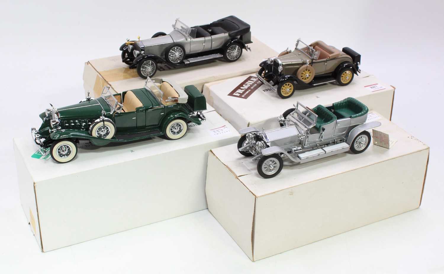 A collection of four various boxed Franklin Mint and Danbury Mint 1/24 scale diecast vehicles to