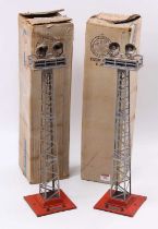 Two Lionel No.92 Floodlight Towers each with twin lights. Red bases, grey towers. Some corrosion