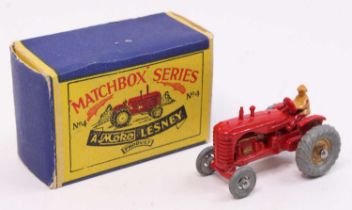 Matchbox Lesney No. 4a Massey Harris Tractor, red body, with tan driver, gold trim, and metal