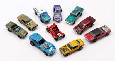 A collection of Hot Wheels Redlines in play-worn condition, with examples including a Mustang Boss