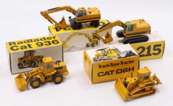 A collection of four boxed Caterpillar 1/50 scale earth moving and construction diecast vehicles