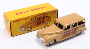 A Dinky Toys No. 344 Estate Car comprising of two tone brown body with matching hubs, housed in