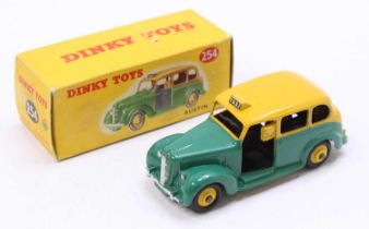 Dinky Toys No. 254 Austin Taxi comprising a yellow and green body with yellow hubs in the original