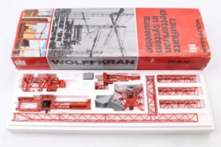 A Conrad diecast model of a Wolff tower system crane, finished in red, and housed in the original