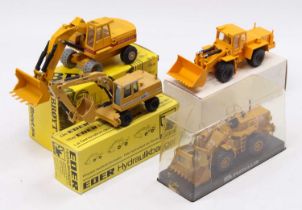 A collection of four mixed scale earth moving and construction diecast vehicles to include an NZG