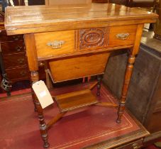 An Aesthetic Movement walnut combination writing/work table, the twin foldover top with gilt