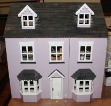 A modern wooden dolls house with opening front together with a selection of furniture & accessories