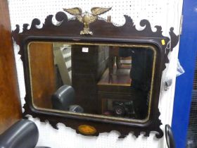 An early 20th century Chippendale style fret cut rectangular bevelled wall mirror, having a floral