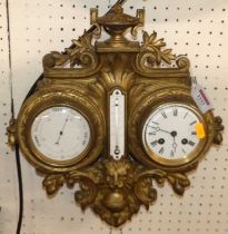 A late 19th century gilt painted cast metal combination clock/barometer, housed in a floral and lion