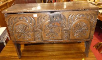 An antique relief carved oak boarded six-plank blanket chest, w.84cm