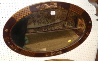 An early 20th century chinoiserie decorated oval bevelled wall mirror, 46 x 71cm