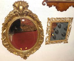 A contemporary French Rococo style floral decorated oval bevelled wall mirror, with scroll surmount,