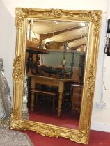 A large contemporary gilt floral decorated bevelled rectangular floor mirror, 185 x 121cm