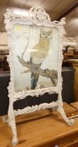 A 19th century Rococo Revival and later white painted carved and floral decorated fire screen,