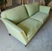 A contemporary green floral upholstered three-seater sofa, in the Victorian taste, having twin squab