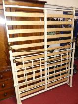 A contemporary painted wrought metal and brass double bedstead, with fixed slatted base section