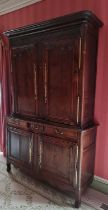 An 18th century provincial French joined oak parlour cupboard, having twin upper and lower doors,