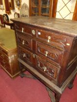 An 18th century geometric joined and moulded oak chest-on-stand, having three graduated drawers, the