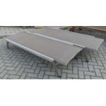 A pair of contemporary teak aluminium clad and canvas inset sun loungers, each with ratchet