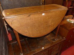 An early 19th century oak padfoot dropleaf dining table