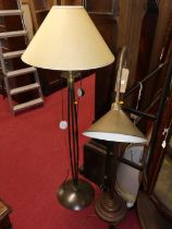 A contemporary brass floor light, having adjustable branch arm and on circular stepped base;