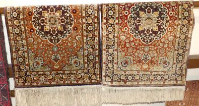 A pair of Chinese silk hall rugs, having tasselled ends, 100 x 63cm Some fading in places and wear