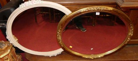 A contemporary floral gilt framed bevelled oval wall mirror, 65.5 x 80cm; together with one other